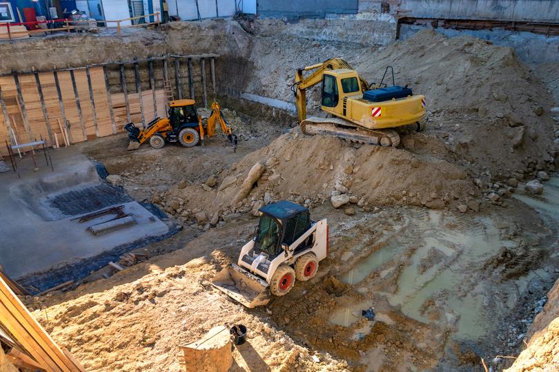 An excavator clearing land for a construction project