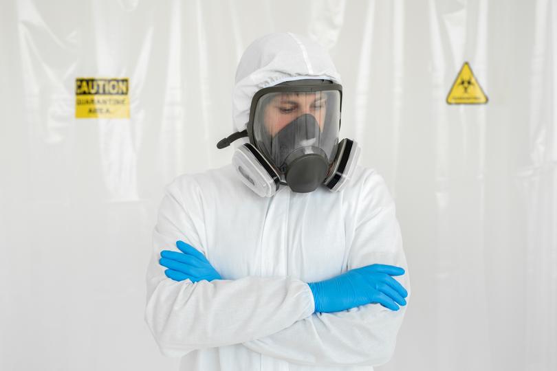 Asbestos removal specialists in protective gear handling asbestos materials safely.