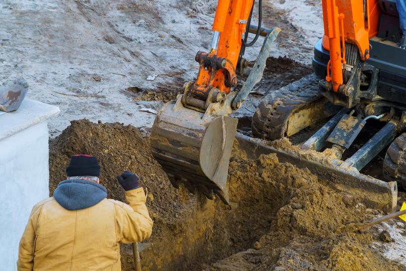 An excavator clearing land for a construction project