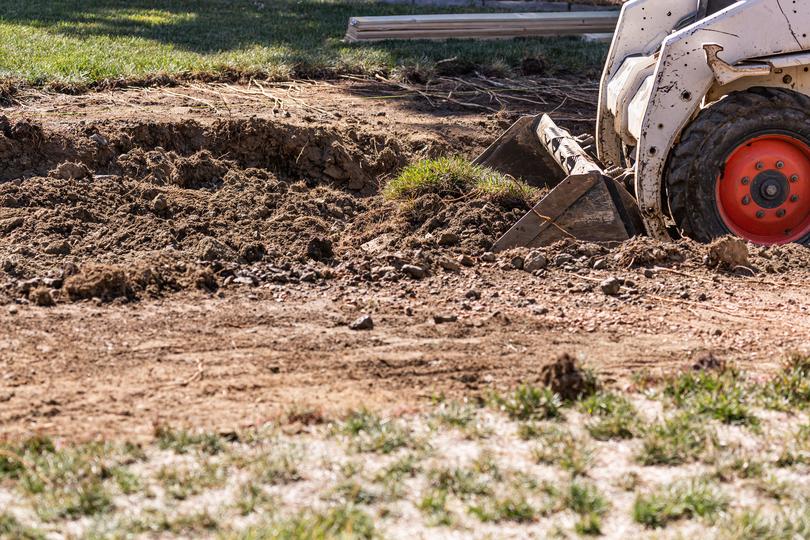 An excavator clearing land for a construction project