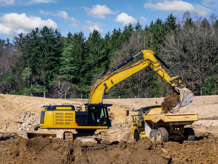 An excavator clearing land for a construction project